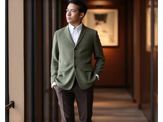 Pria mengenakan sweater tipis berkualitas tinggi di atas kemeja berkancing, dipadukan dengan celana bahan dan sepatu derby.